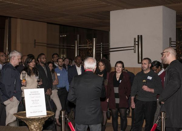 Speaking to attendees at a professional networking event